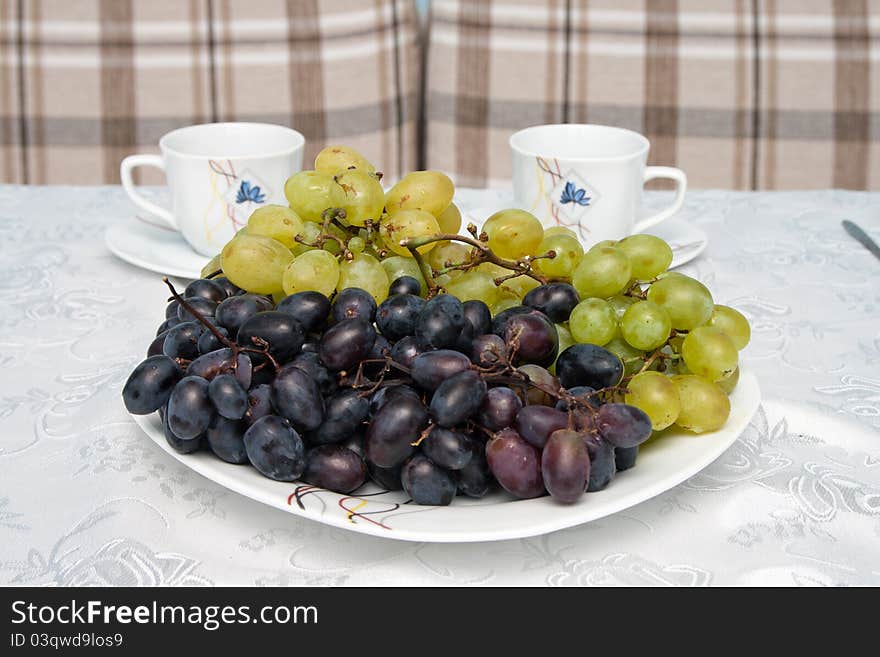 Grapes and cups on the table. Grapes and cups on the table