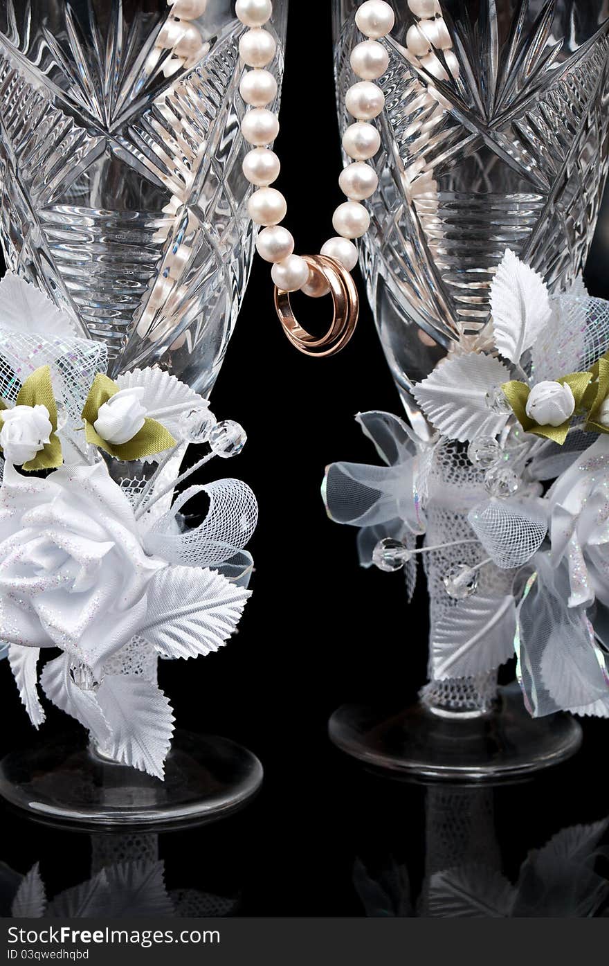 Wedding glass and rings isolated on a black background