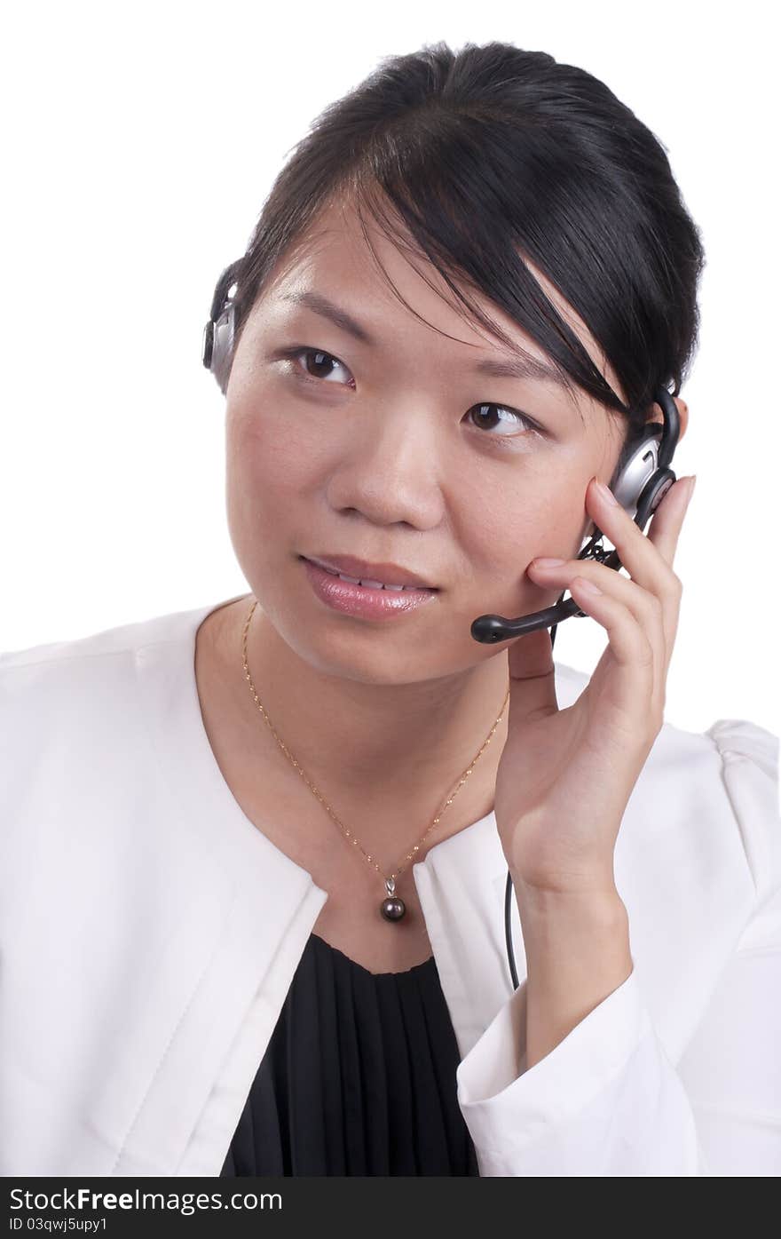 Young asian receptionist talking on hands free headset to customer isolated. Young asian receptionist talking on hands free headset to customer isolated