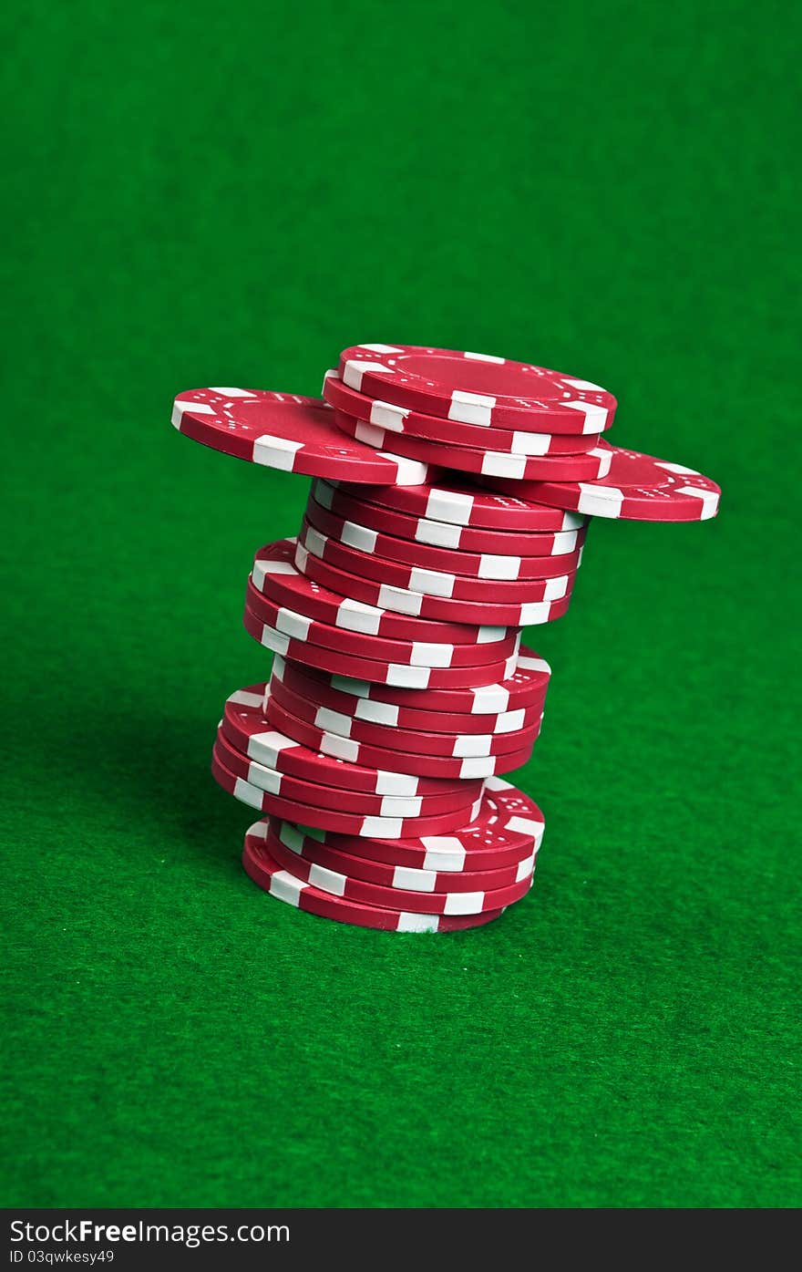 Poker chips on a green table background