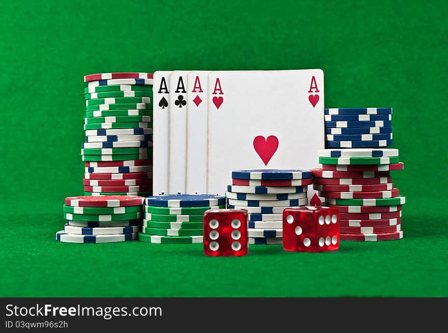 Four aces and poker chips on a green felt