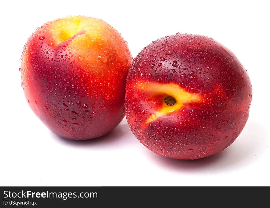 Two fresh nectarines with water