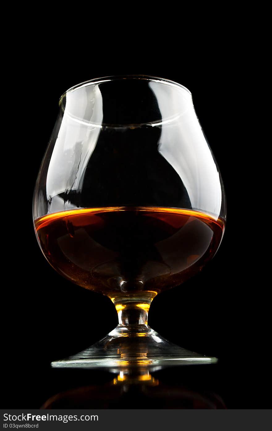 Whiskey in a classic glass isolated on a black background