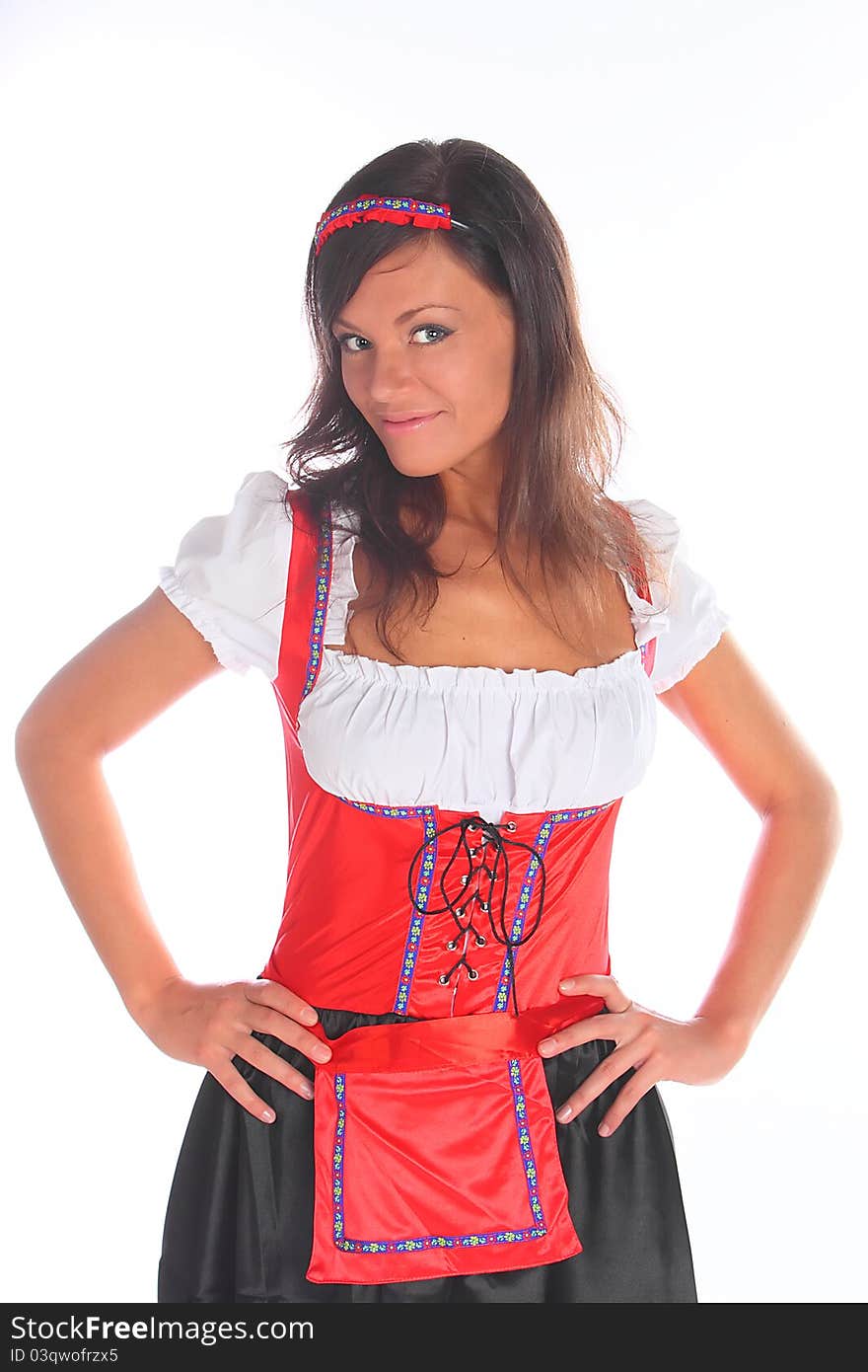 The girl in a traditional Bavarian dress with full glasses of beer in hands