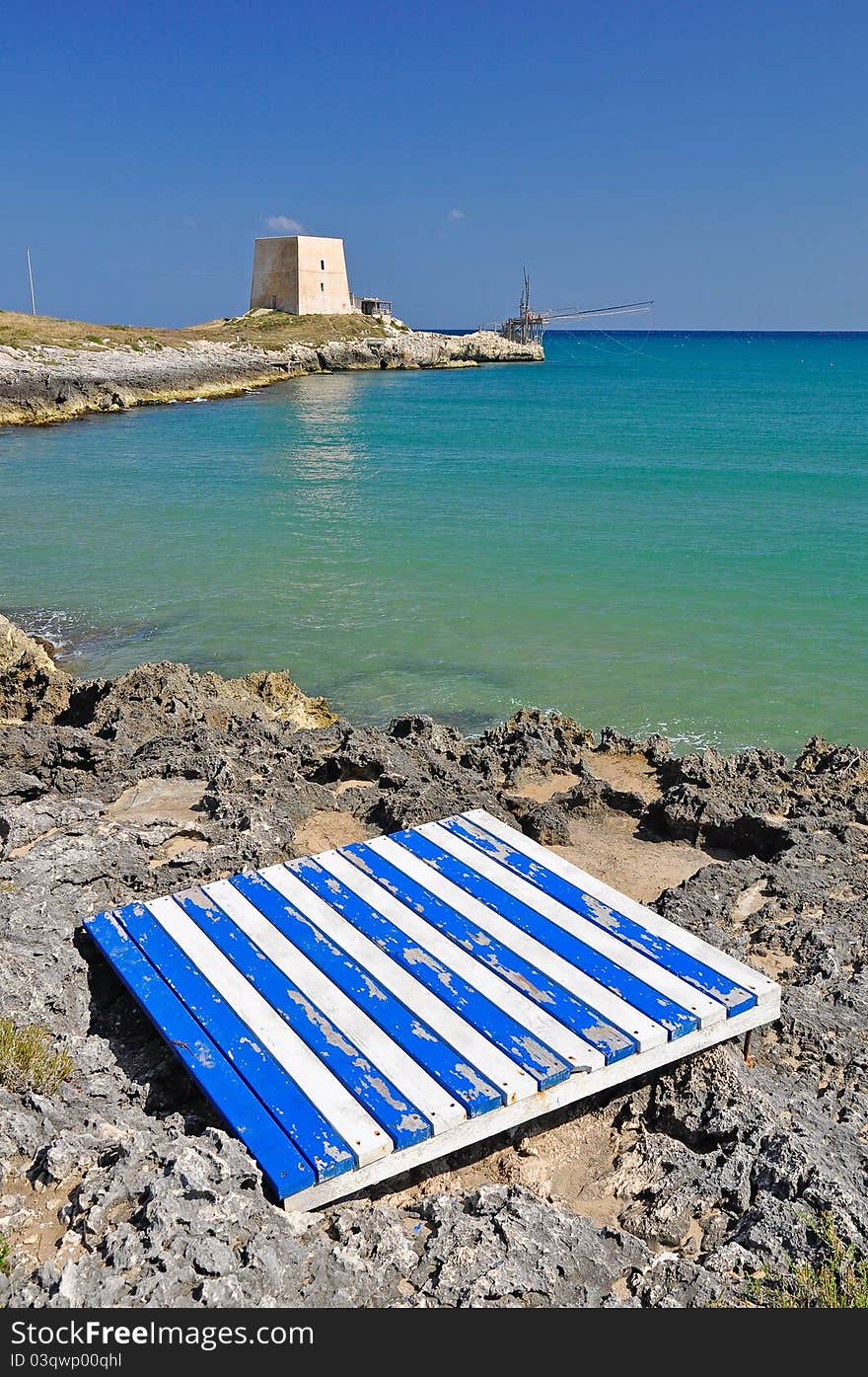 Bay of Manacore, near Peschici, with an ancient Torre Saracena, typical lookout tower of the coast of Gargano. Apulia. Italy. Bay of Manacore, near Peschici, with an ancient Torre Saracena, typical lookout tower of the coast of Gargano. Apulia. Italy.