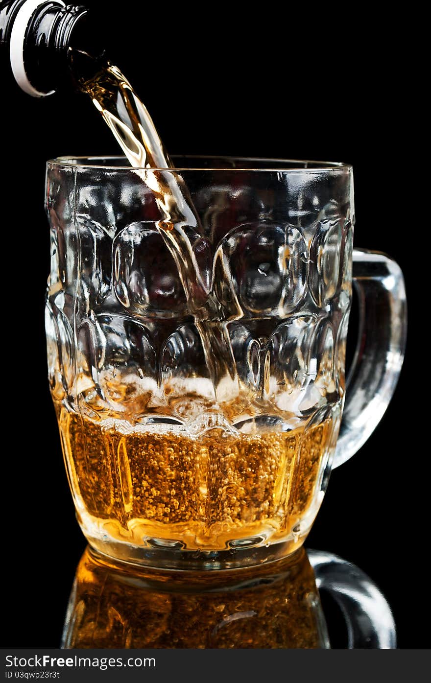 Fresh glass of beer isolated on a black background