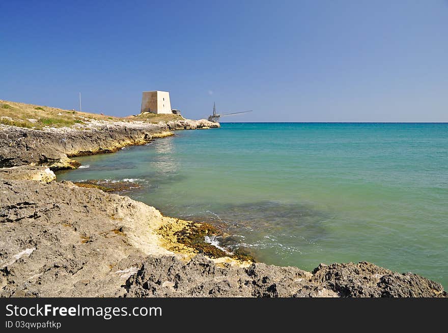 Bay of Manacore, near Peschici, with an ancient Torre Saracena, typical lookout tower of the coast of Gargano. Apulia. Italy. Bay of Manacore, near Peschici, with an ancient Torre Saracena, typical lookout tower of the coast of Gargano. Apulia. Italy.