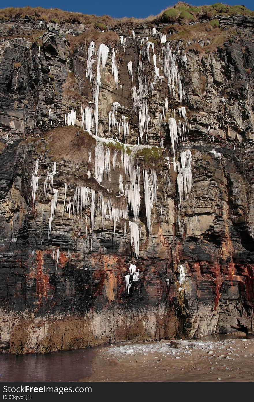 Melting Cascade Of Icicles On A Cliff Face