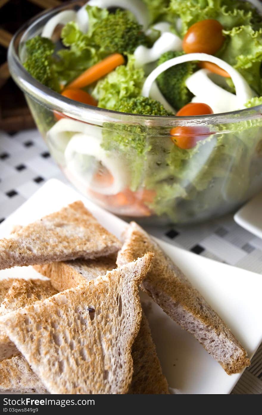 Healthy food green salad with wheat toasts