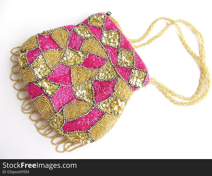 A purse decorated with beads and sequences work on white background. A purse decorated with beads and sequences work on white background.