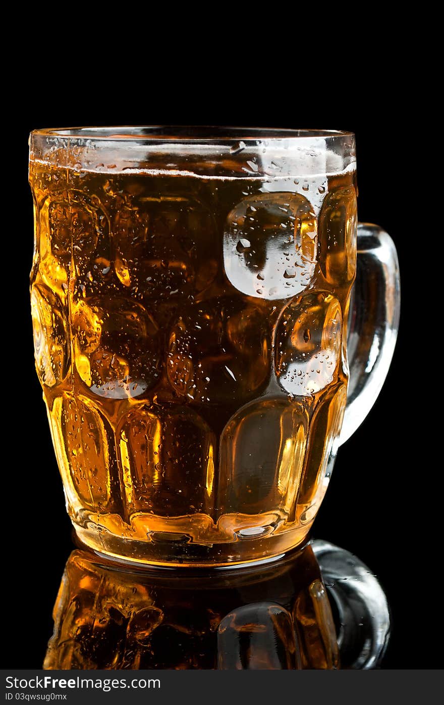 Fresh glass of beer isolated on a black background