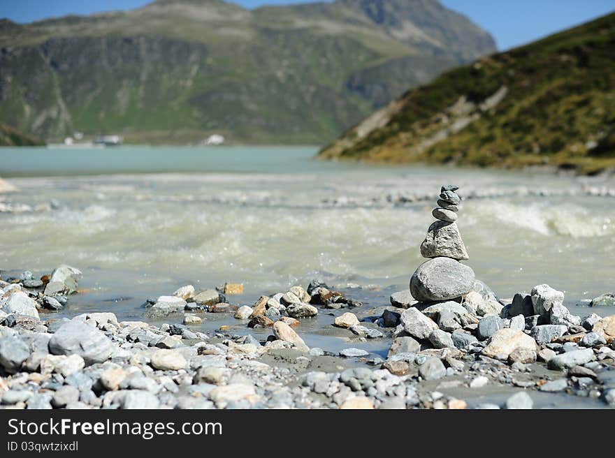 Cairn on the shore of a mountain lake in Austria