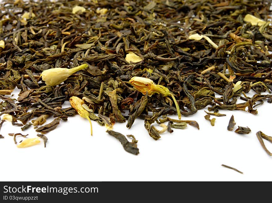 Green tea leaves and jasmine on a white background