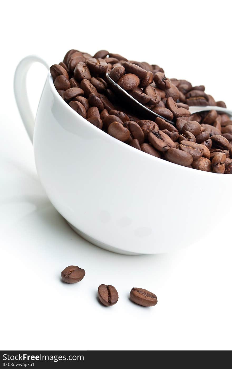 Full cup with coffee beans isolated on a white background