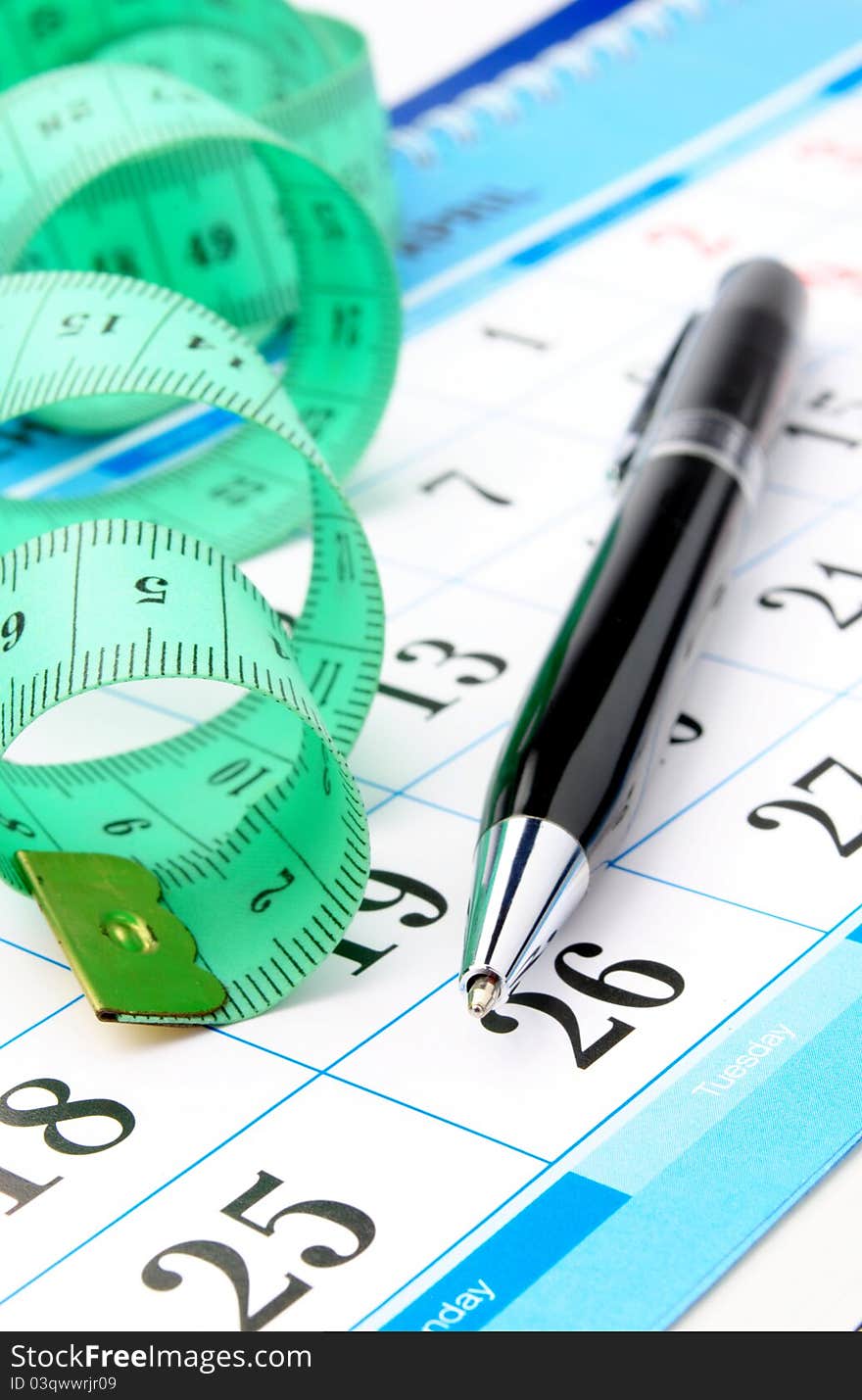 Measuring tape, calculator and pen are shown in close-up. Measuring tape, calculator and pen are shown in close-up