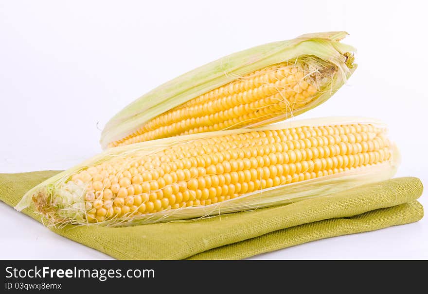 Corn on a white background and green texture