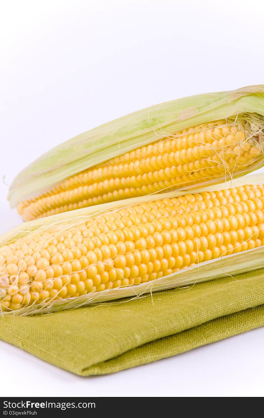 Corn on a white background and green texture