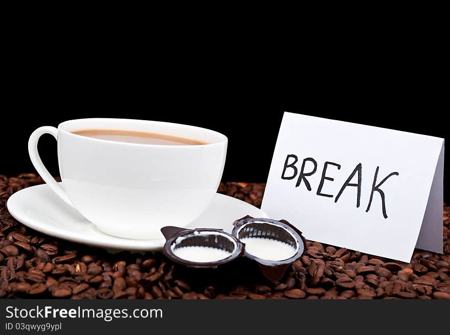 Coffee with milk and coffee beans on a black background