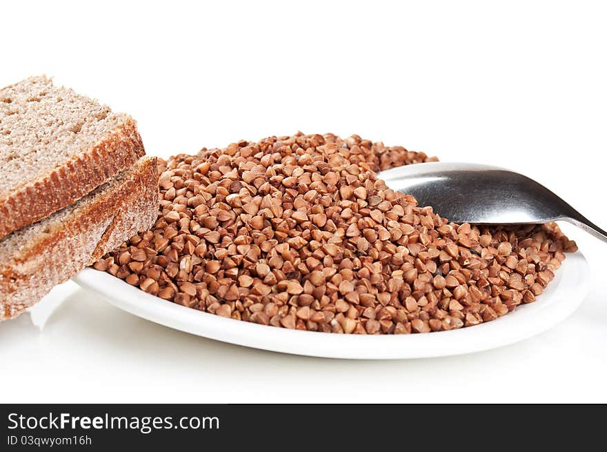 Buckwheat and bread on plate isolated on a white background