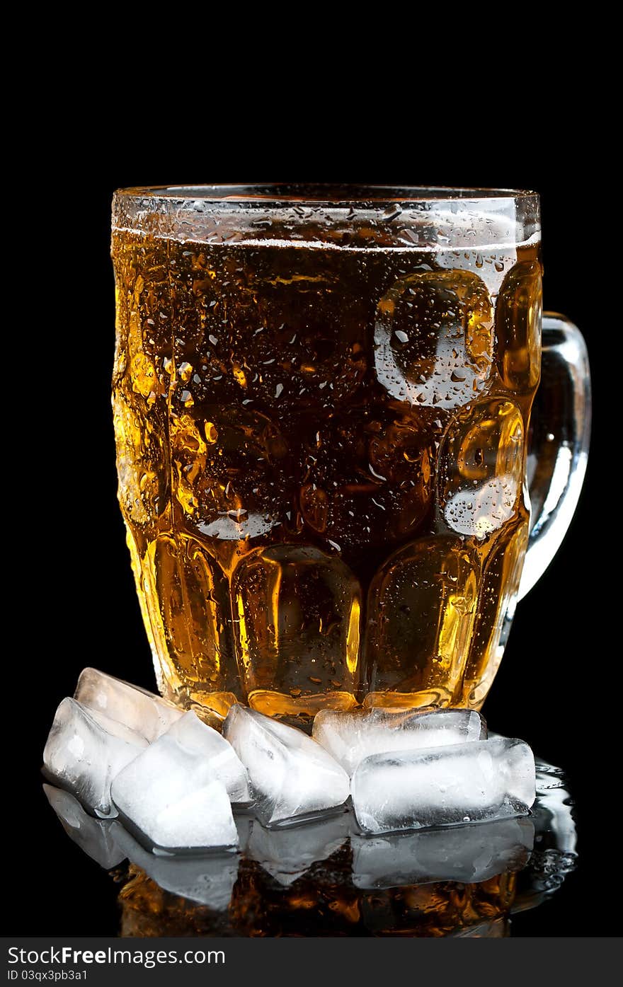 Cold beer in glass and ice isolated on a black background. Cold beer in glass and ice isolated on a black background