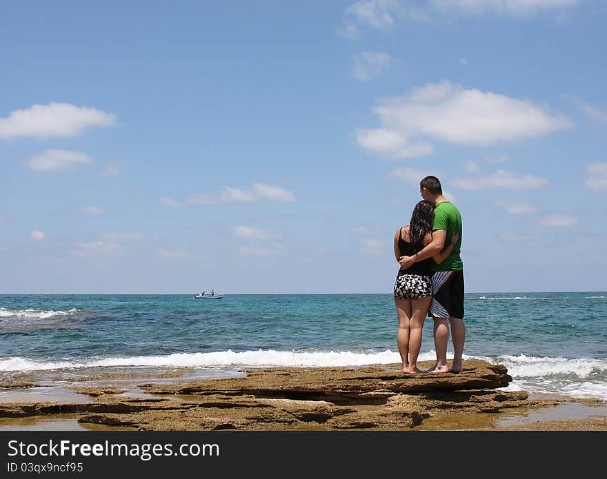 Young men and women walking on the shore of the Mediterranean Sea. Young men and women walking on the shore of the Mediterranean Sea.