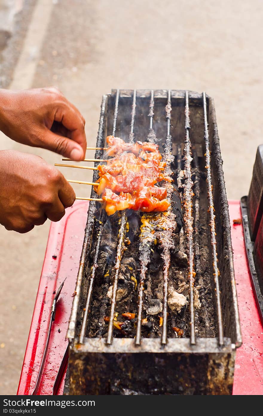 Moo ping, a thai food make by pork grilled on charcoal. Moo ping, a thai food make by pork grilled on charcoal