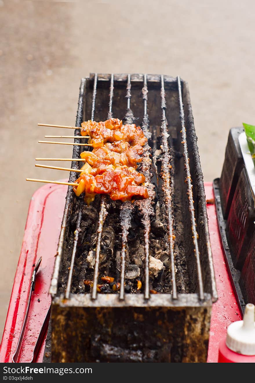 Moo ping, a thai food make by pork grilled on charcoal. Moo ping, a thai food make by pork grilled on charcoal