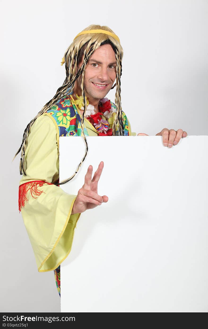 Man dressed in hippy costume holding blank message board. Man dressed in hippy costume holding blank message board