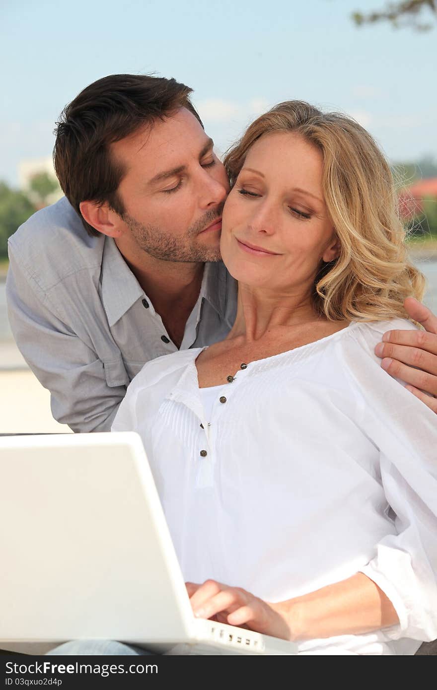 Man kissing a women tenderly on the cheek. Man kissing a women tenderly on the cheek