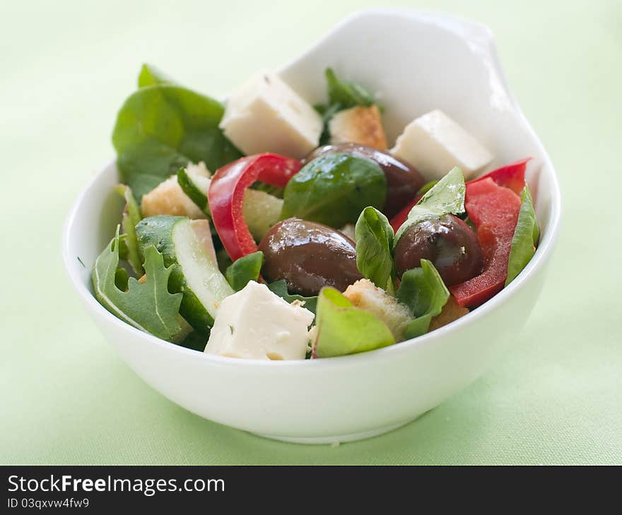 Fresh vegetable salad with calamata olives, crouton and cheese. Selective focus