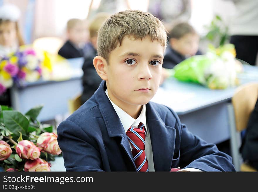 Portrait of first-grader boy sitting patiently at his desk waiting for the teacher. Portrait of first-grader boy sitting patiently at his desk waiting for the teacher