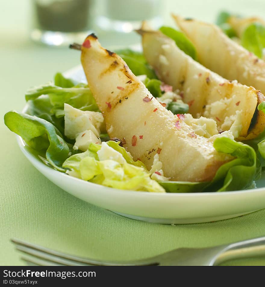 Fresh salad with pear and goat cheese. Selective focus