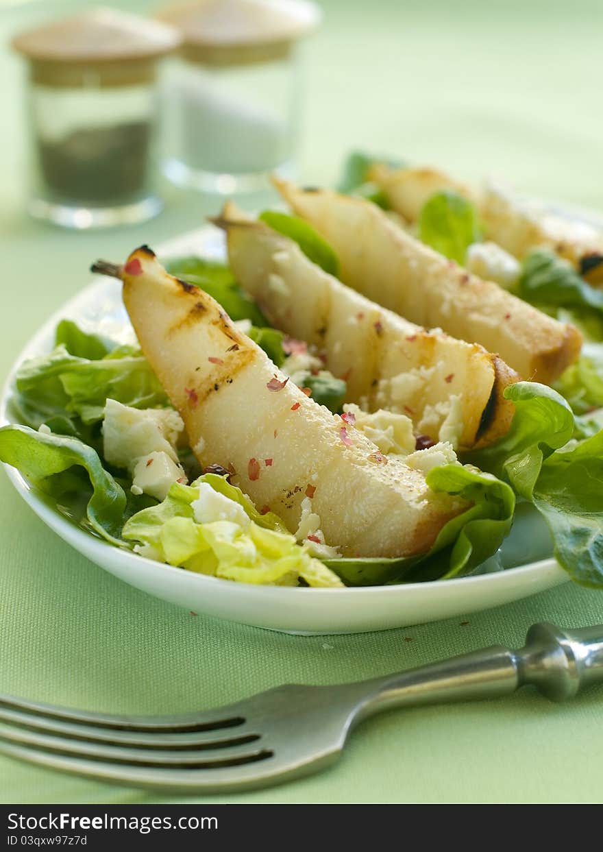 Fresh salad with pear and goat cheese. Selective focus