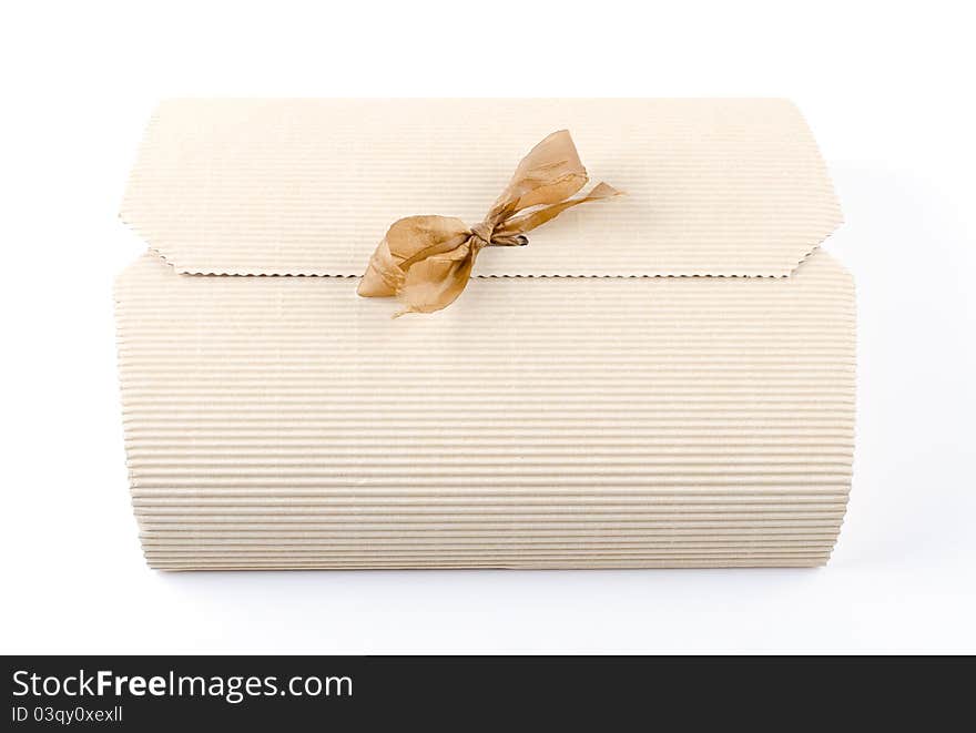 White gift box tied with a gold ribbon bow. on white background. White gift box tied with a gold ribbon bow. on white background.