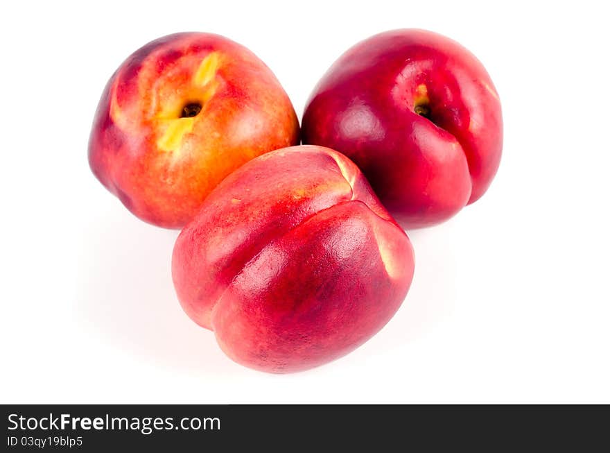 Studio shot of three nectarines on white background