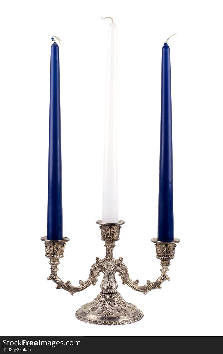 Studio shot of antique silver candlestick with candles on a white background