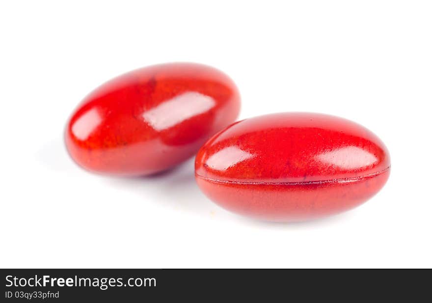 Studio shot of red capsules on white background