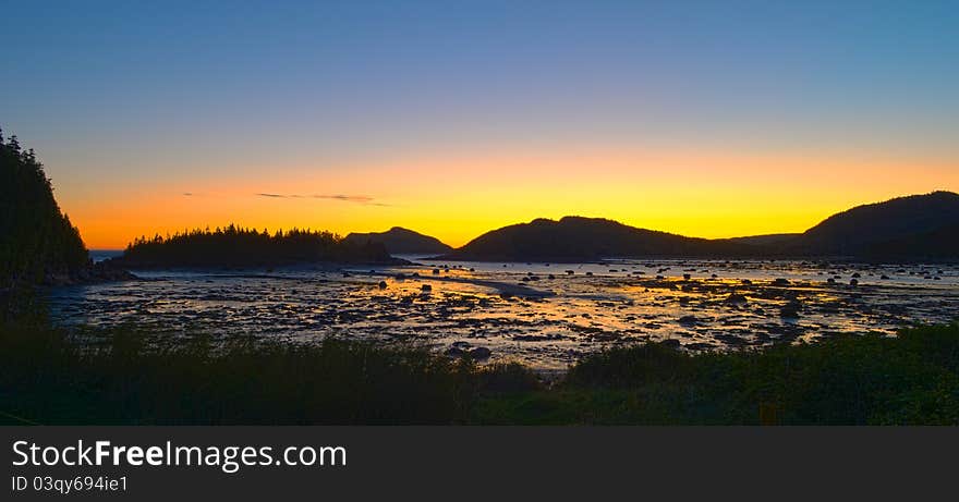 Sunrise in mountains at low tide