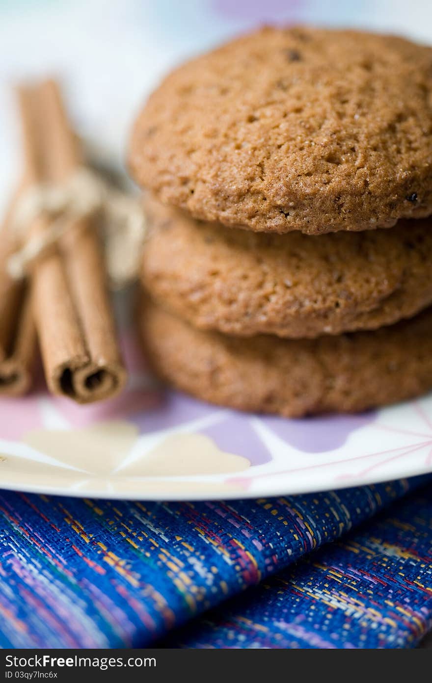 Cookies and cinnamon sticks on a plate. Cookies and cinnamon sticks on a plate