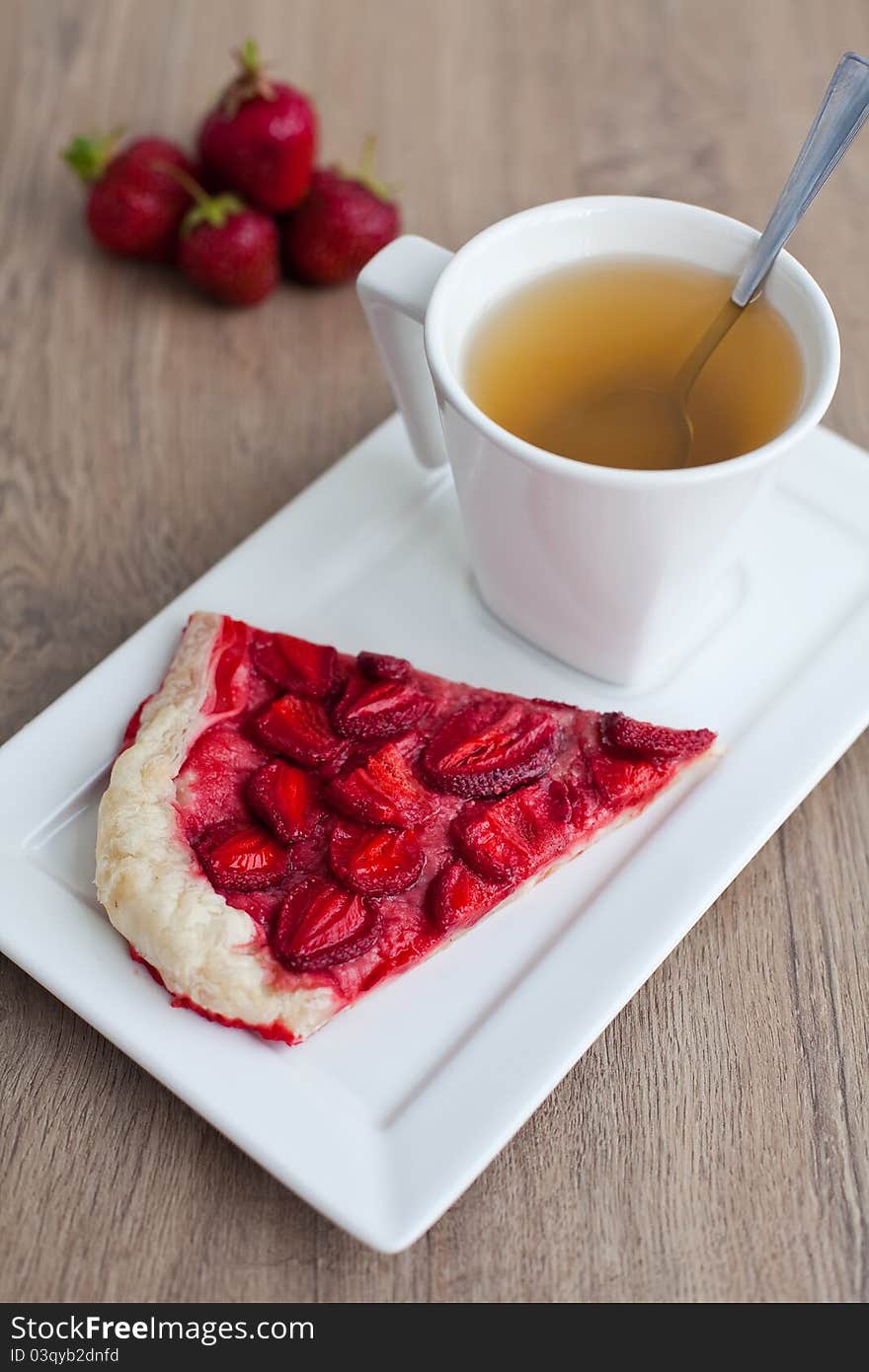 Close-up homemade strawberry pie and a cup of tea