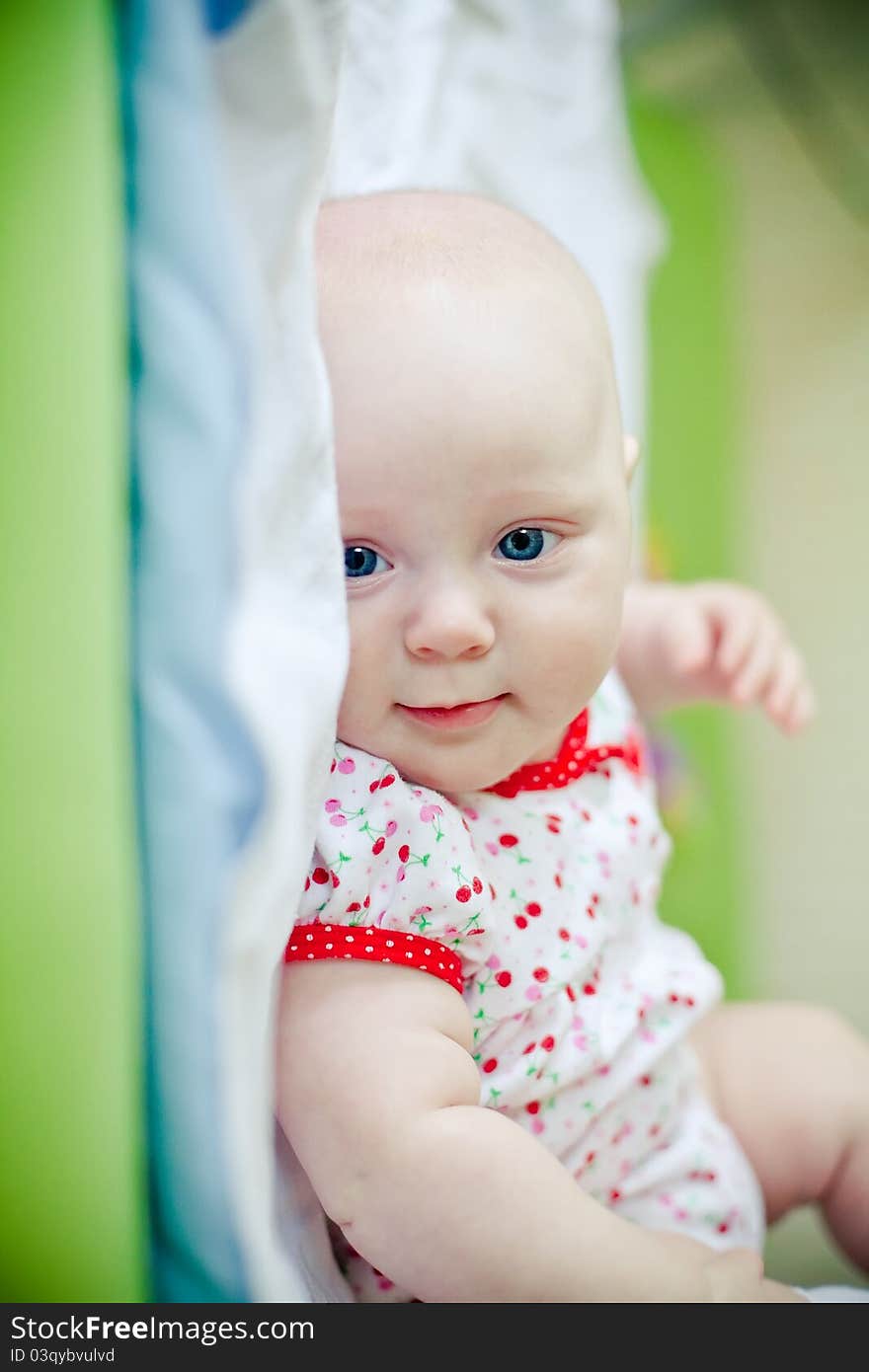 Little smiling baby girl lying in her bed. Little smiling baby girl lying in her bed