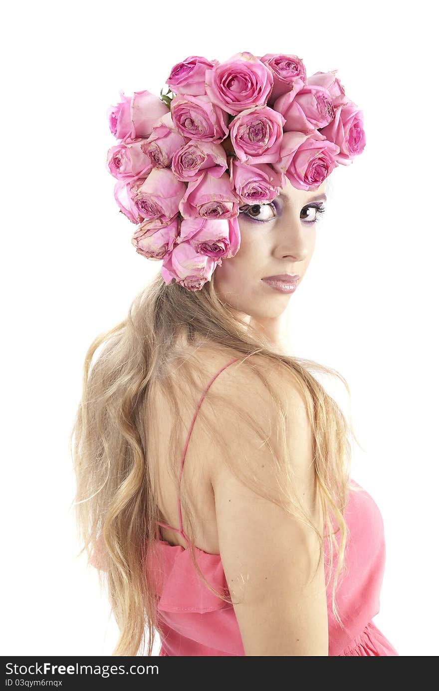 Young beautiful woman with pink flowers on her head over white