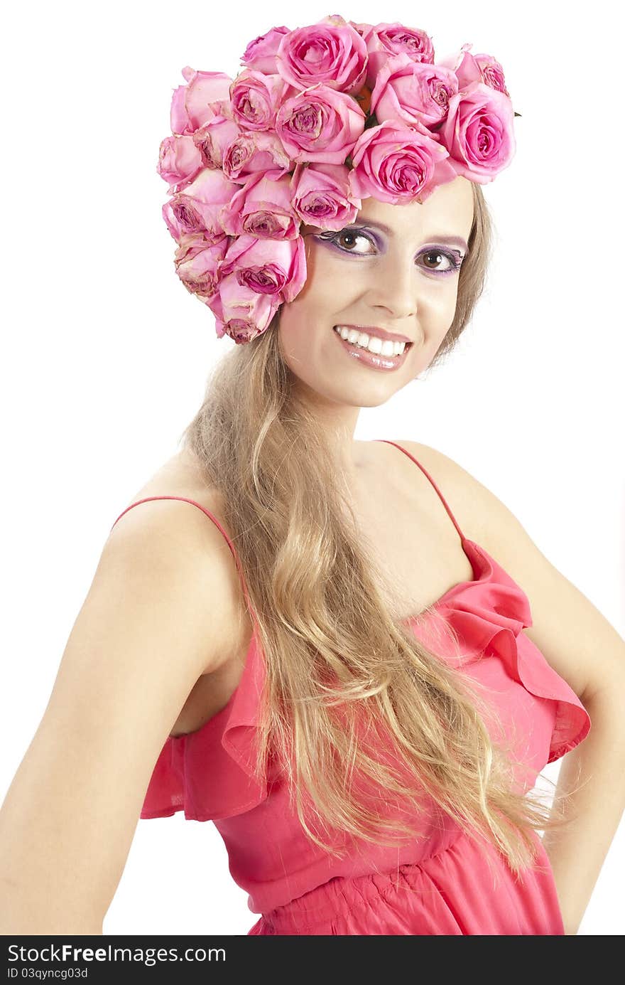 Young beautiful woman with pink flowers on her head over white