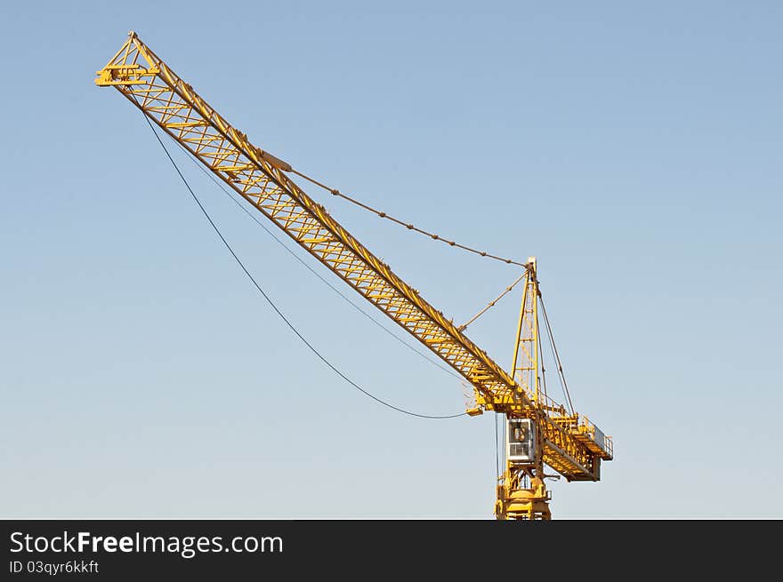 Yellow crane against blue sky