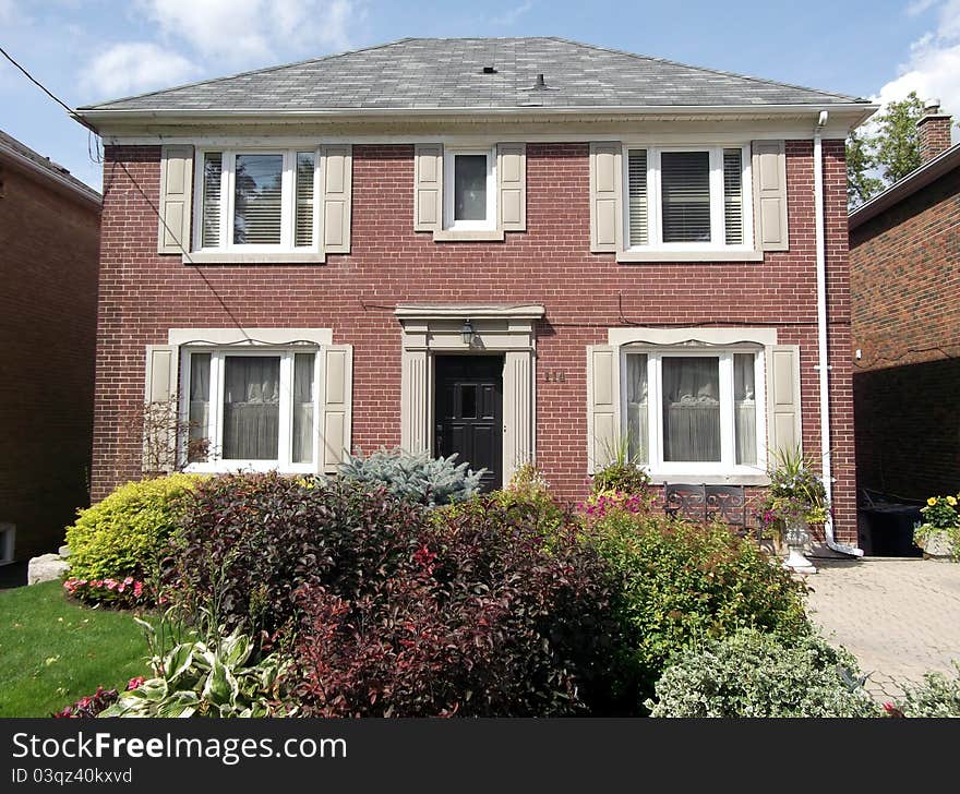 A large 2 story red brick family house. A large 2 story red brick family house