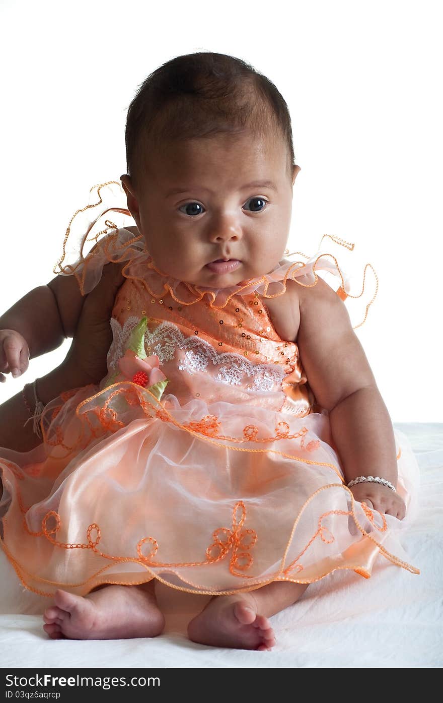 5 months old Baby girl dressed in cute pink dress on white background. 5 months old Baby girl dressed in cute pink dress on white background