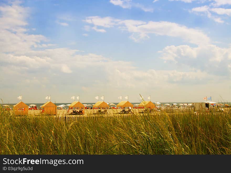 Multiple yellow stripes tents at the beach. Multiple yellow stripes tents at the beach