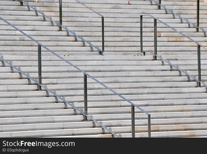 Concrete stage and metal handrail in repeated pattern and design, shown as industrial architecture or featured pattern and texture. Concrete stage and metal handrail in repeated pattern and design, shown as industrial architecture or featured pattern and texture.