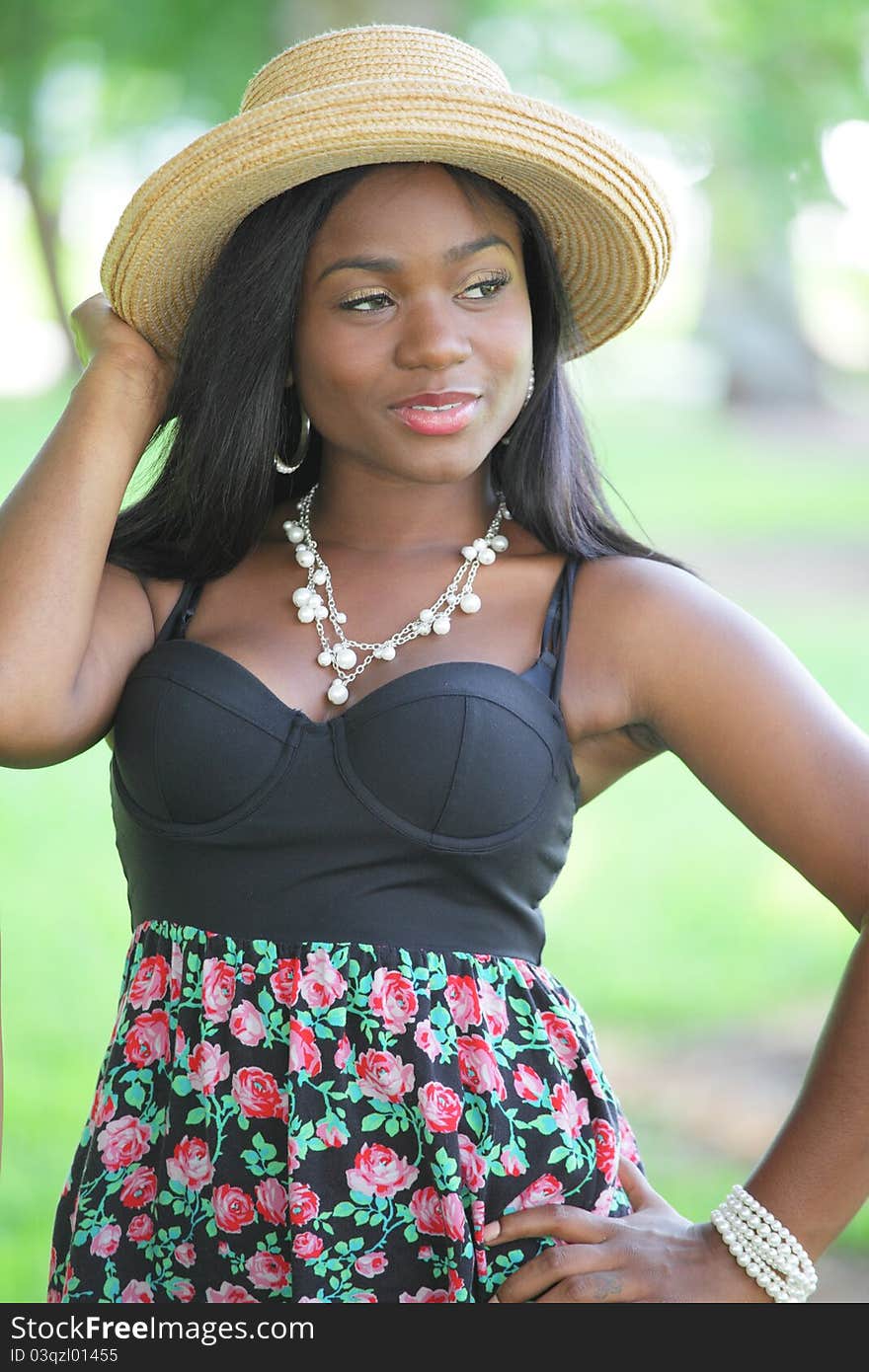 Image of a young black model with a straw hat. Image of a young black model with a straw hat