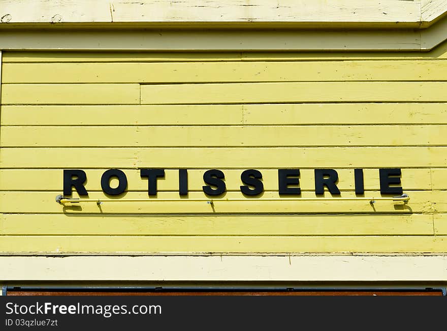 Rotisserie sign on wooden wall on grunge wooden wall